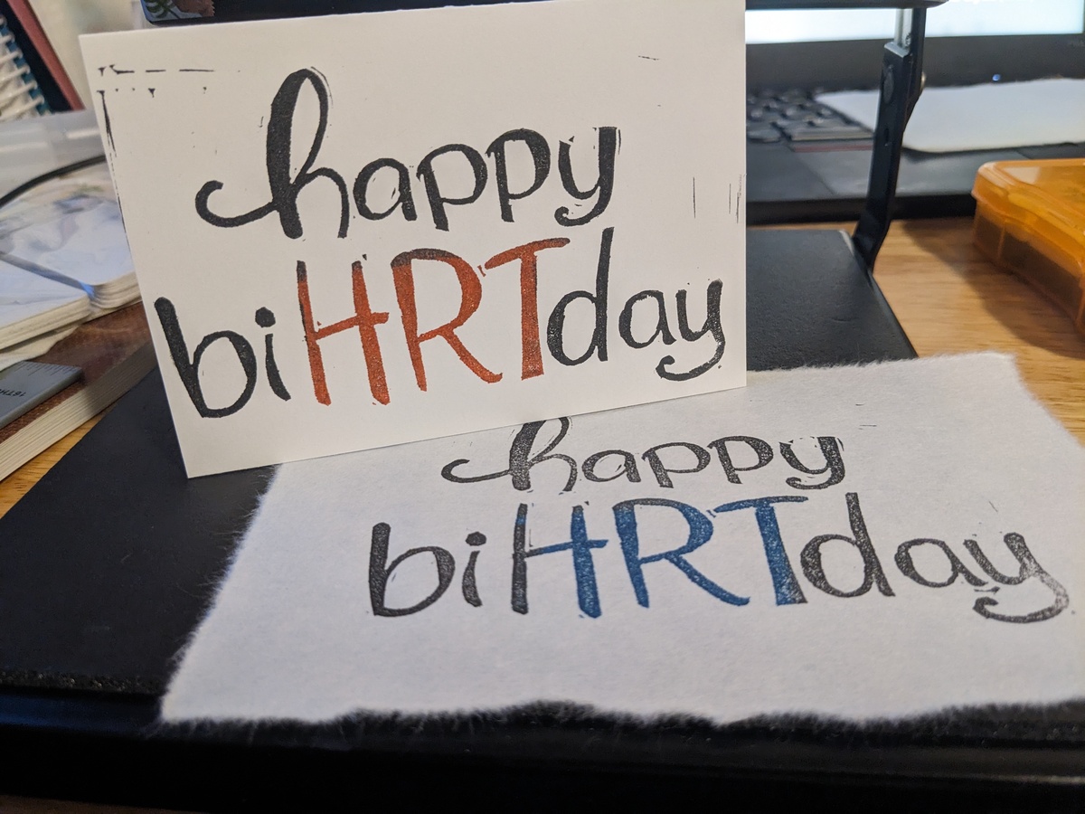 A card and print in the same design - a bouncy, cheery font reading 'happy biHRTday'