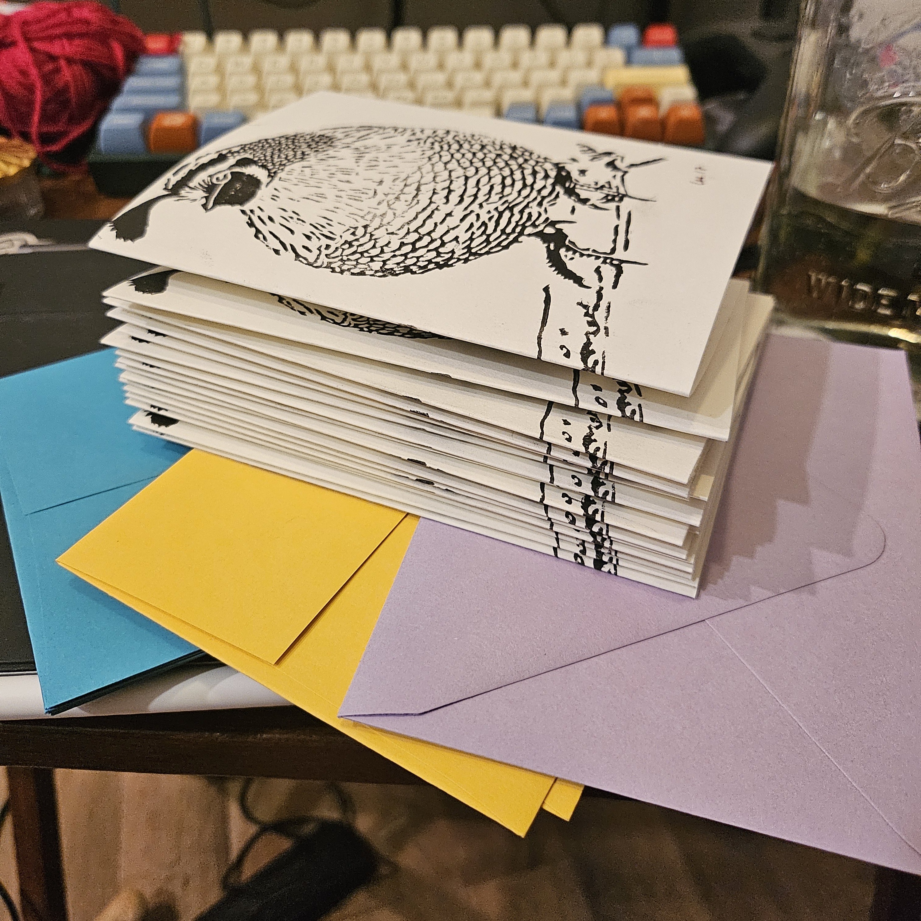 A pile of hand-printed A2 size greeting cards. Only the front is visible, showing a particularly round quail.