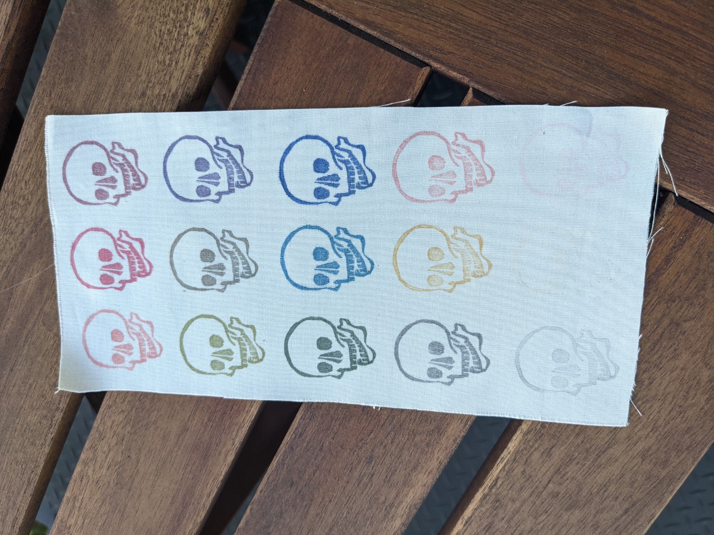 A piece of fabric stamped with skulls in varying colors