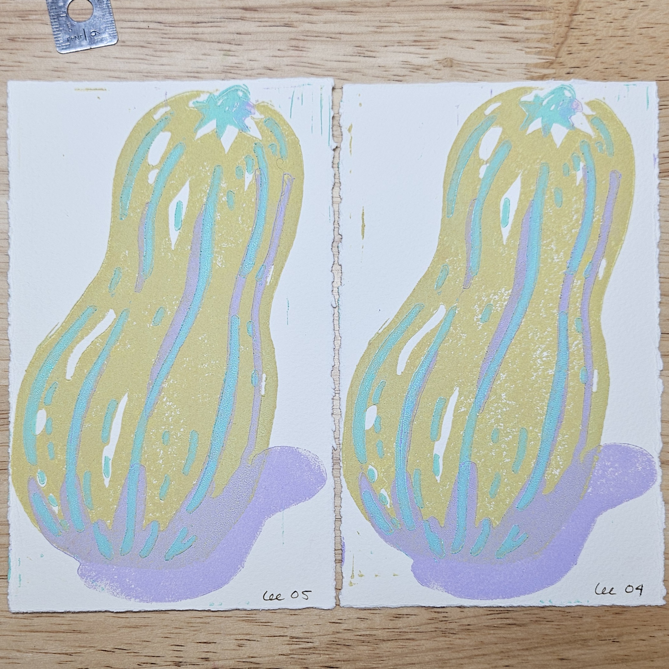 Two identical prints of a delicata squash. The body of the squash is cornsilk (muted yellow), the stem and stripes in mint green, and the shadows in lilac.