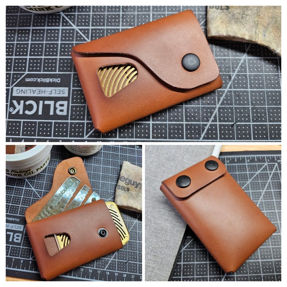 A card wallet with one main pocket and one quick access slot with a thumb slide. The cover of the main pocket curves around the thumb slide.