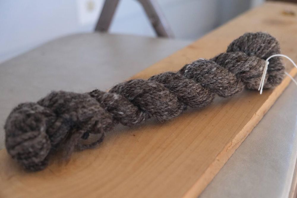 a skein of dark grey handspun yarn