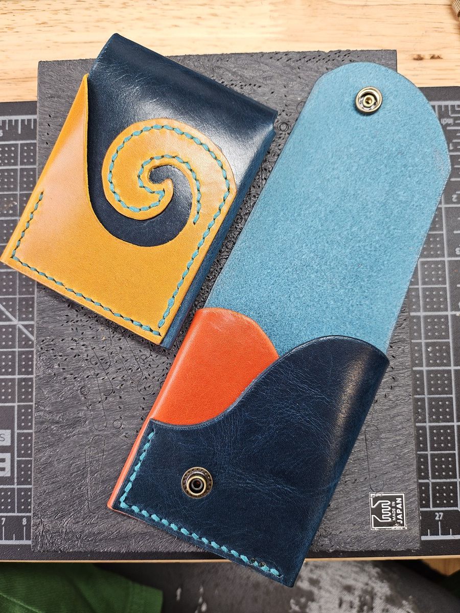 A collage showing 3 pictures of a red and brown leather card wallet. The red pocket separator folds around to the back to become a fetching curlicue.